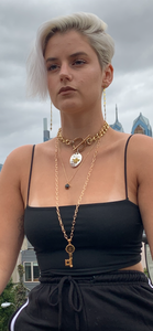 White moon enamel pendant on gold link chain.